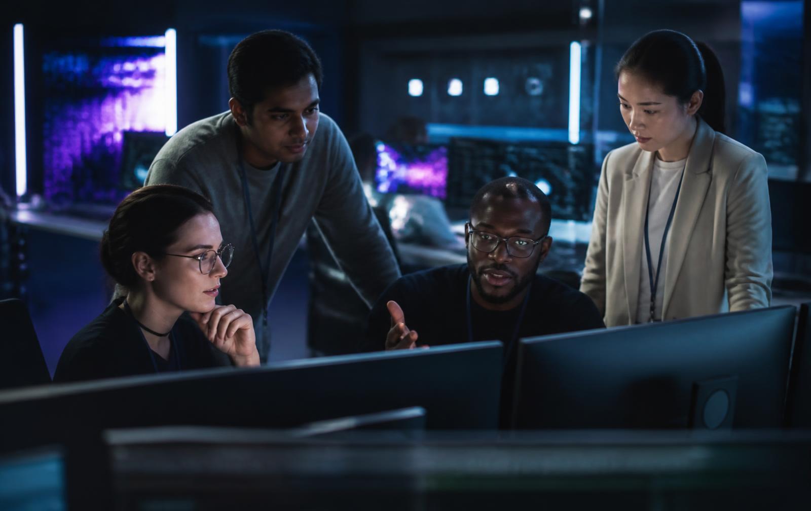 A team of IT professionals collaborating in a modern operations center